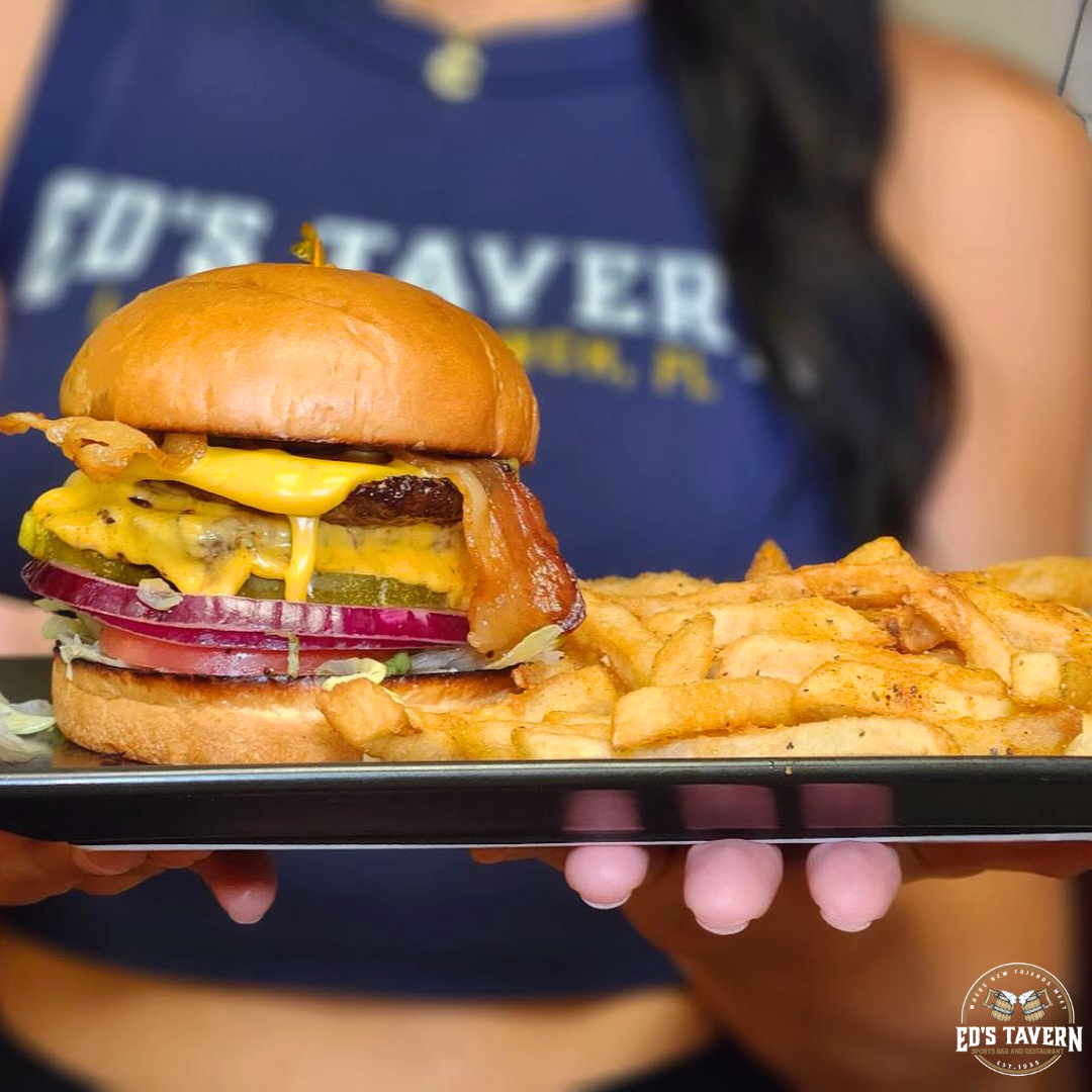 Ed's Tavern smashburger with melted cheese, bacon, pickles, and red onion served with house-seasoned fries on Lakewood Ranch Main Street