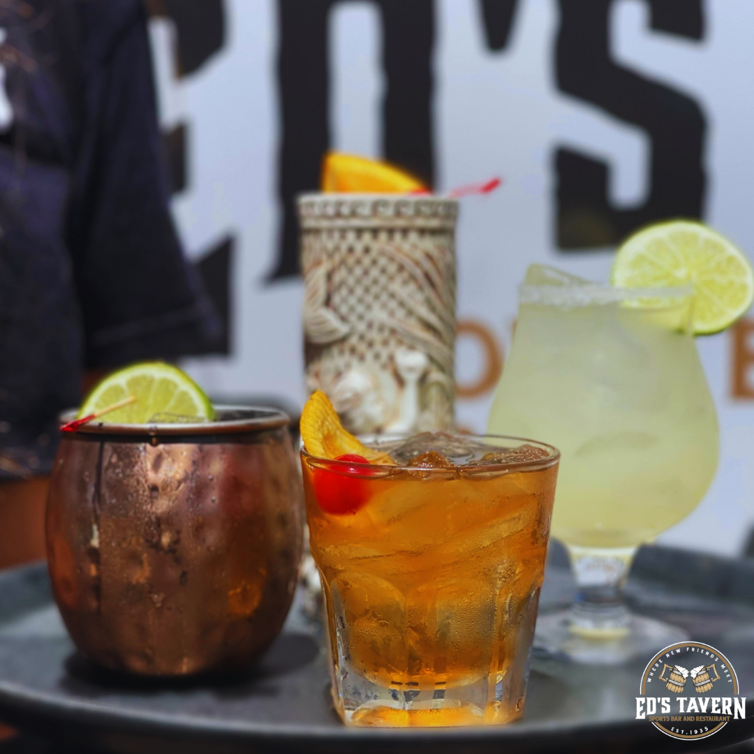 Signature cocktails including a Moscow Mule, Old Fashioned, and margarita served during happy hour at Ed's Tavern SR64 in Bradenton