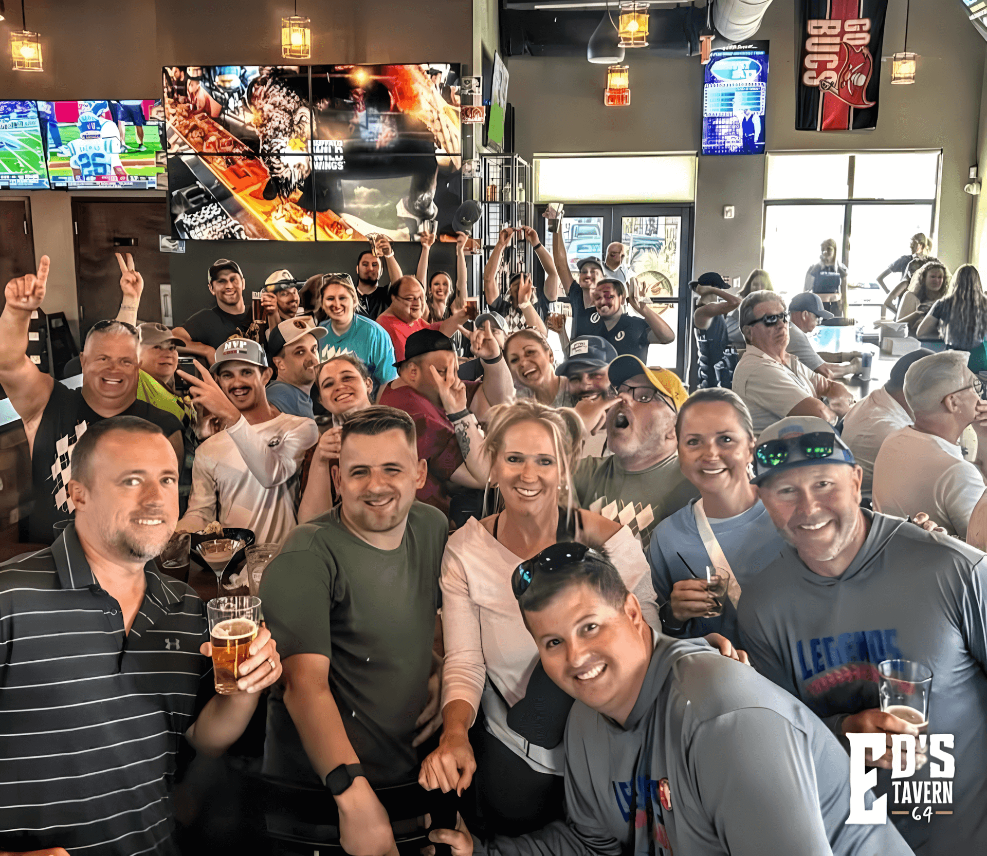 Large group of fans cheering and celebrating a game day at Ed's Tavern family-friendly sports bar in Bradenton